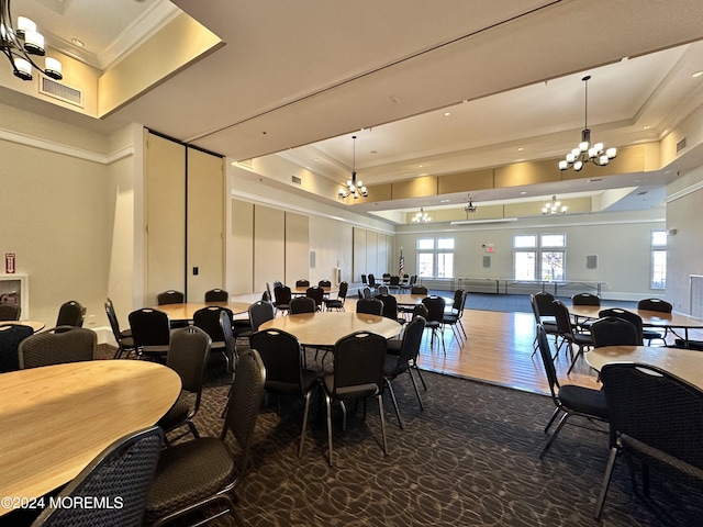 dining room with crown molding, a tray ceiling, and a notable chandelier