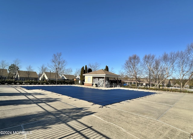 community pool with fence, a patio, and a gazebo