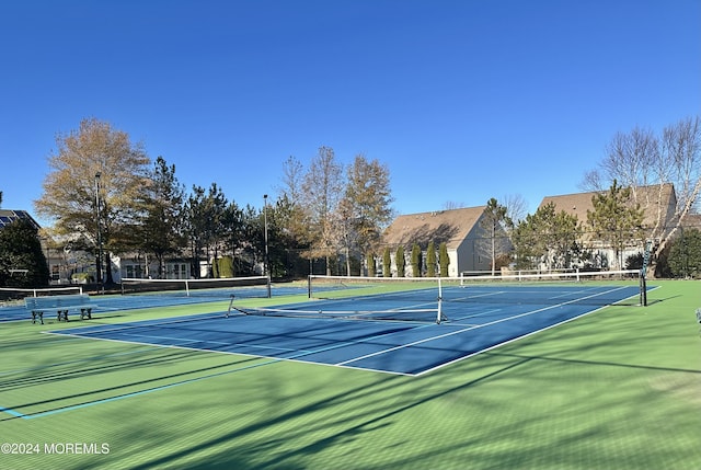 view of tennis court with fence