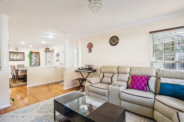 living room featuring light wood-type flooring and crown molding