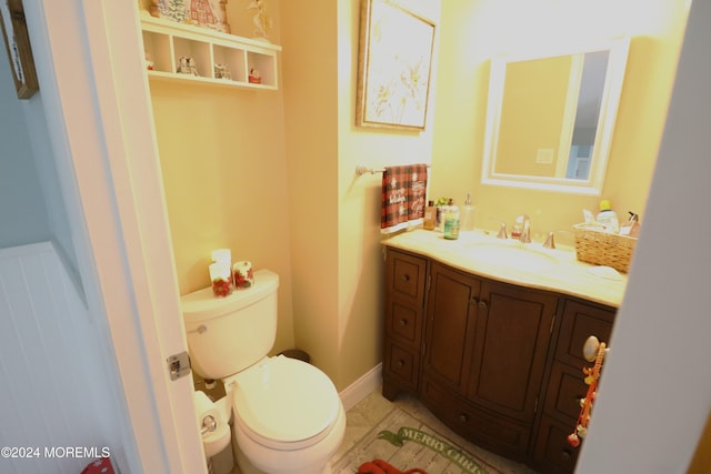 bathroom featuring toilet, tile patterned floors, and vanity