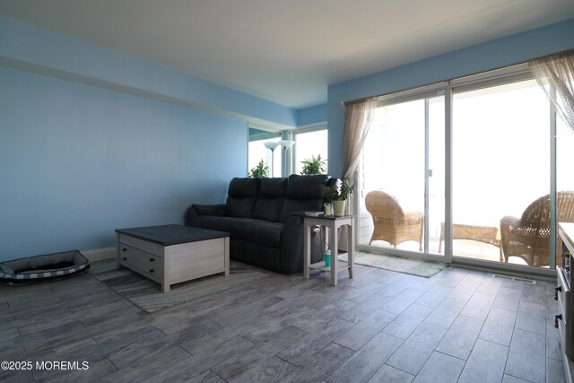 living area featuring wood finished floors and baseboards