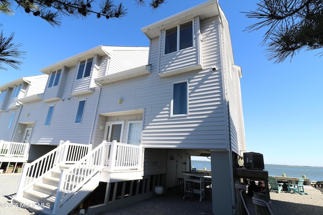 back of property with a water view