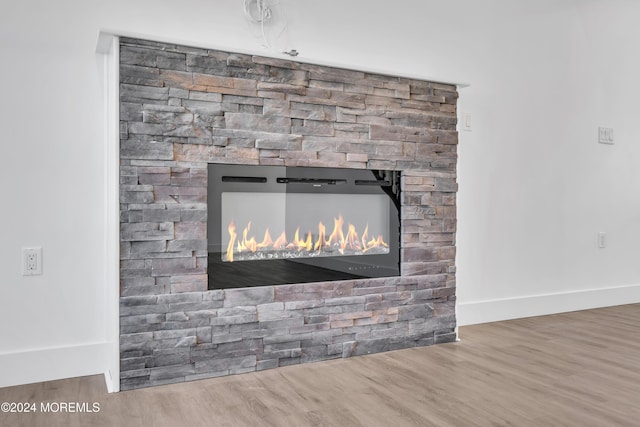 room details featuring a fireplace and hardwood / wood-style floors