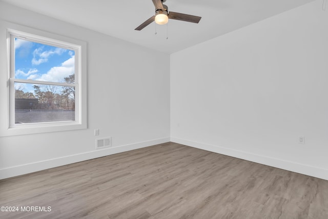 empty room with light hardwood / wood-style flooring and ceiling fan