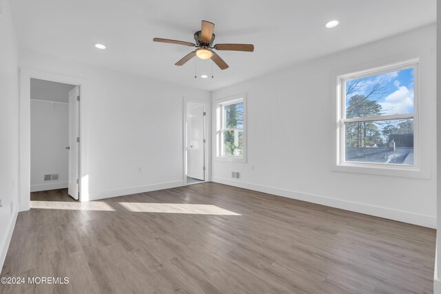 empty room with ceiling fan and hardwood / wood-style flooring