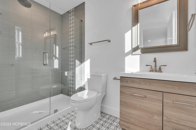 bathroom featuring tile patterned floors, vanity, an enclosed shower, and toilet