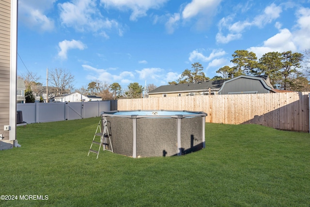 view of yard with a fenced in pool