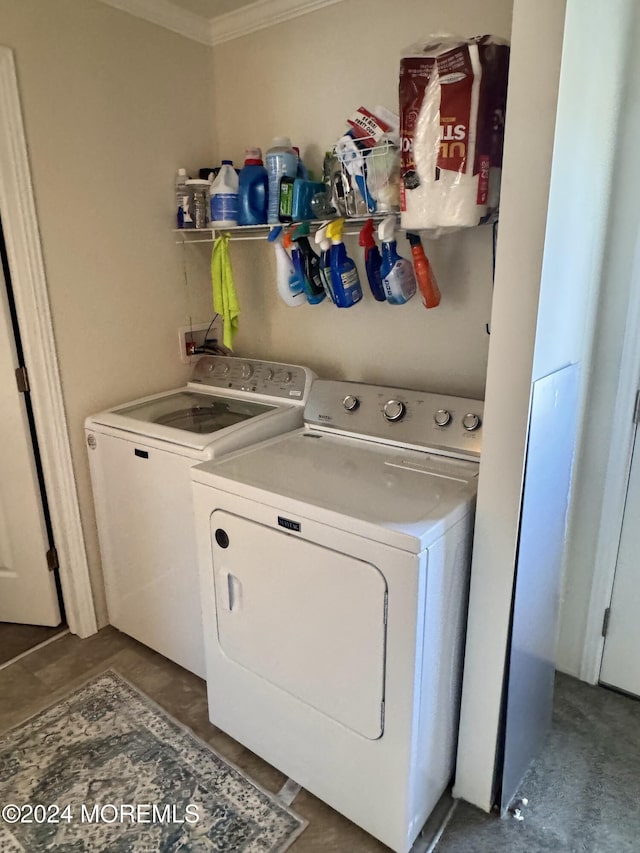 laundry area with crown molding and separate washer and dryer