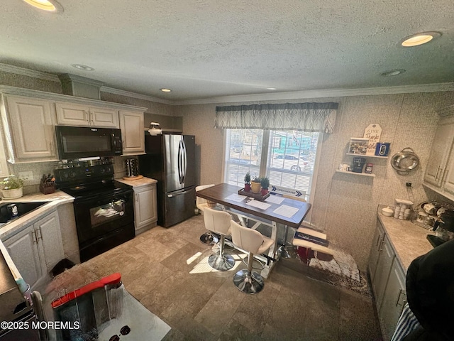 kitchen featuring sink, white cabinets, a textured ceiling, and black appliances