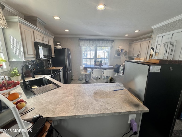 kitchen featuring crown molding, black appliances, kitchen peninsula, and a kitchen breakfast bar