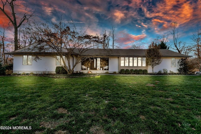 ranch-style home featuring a yard