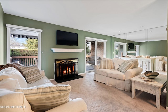 living room featuring a wealth of natural light and light colored carpet