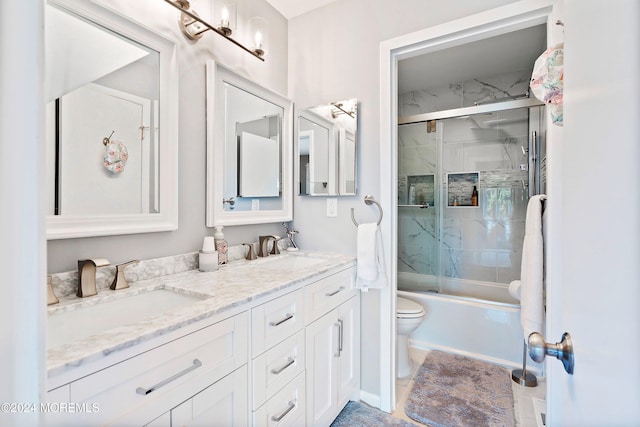 full bathroom with tile patterned floors, vanity, enclosed tub / shower combo, and toilet