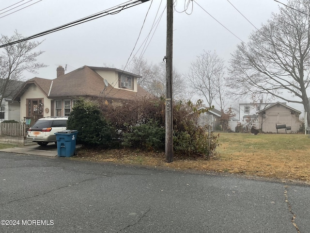 view of side of home with a yard