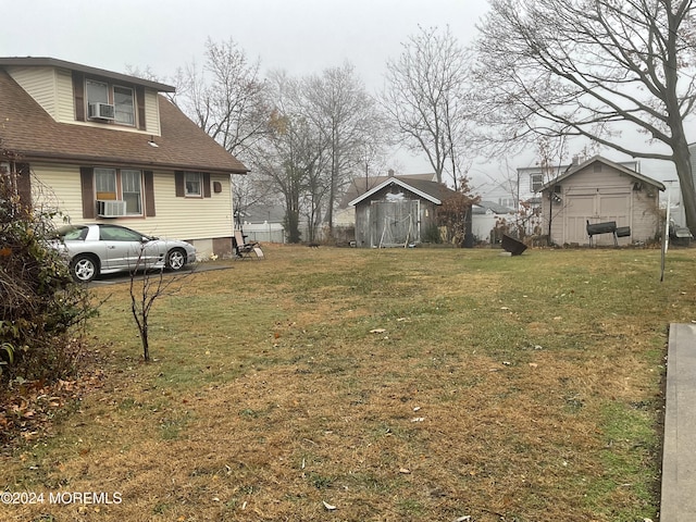 view of yard featuring cooling unit and a storage shed