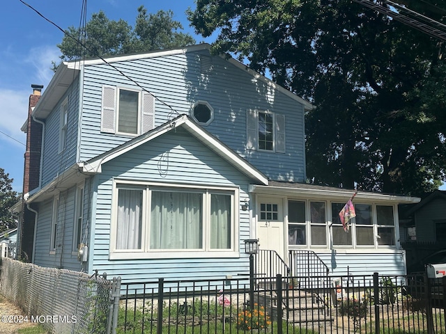 view of front of house featuring a sunroom