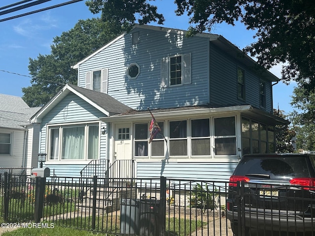 view of front of home with a sunroom