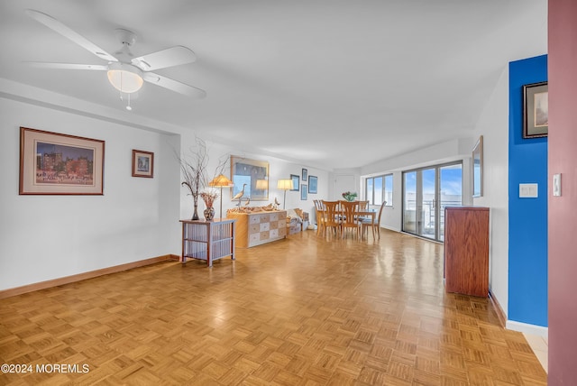 living room featuring ceiling fan and light parquet flooring