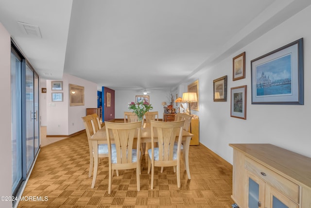 dining area featuring light parquet floors