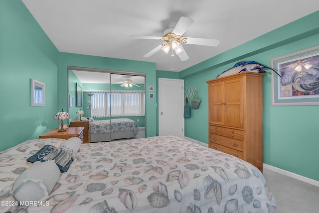 tiled bedroom with ceiling fan and a closet