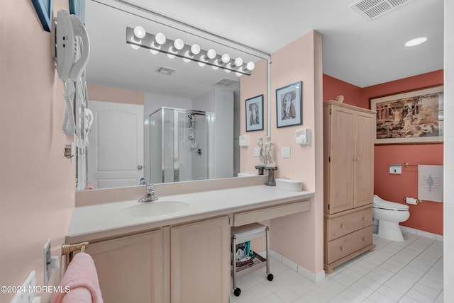 bathroom with toilet, vanity, tile patterned floors, and an enclosed shower