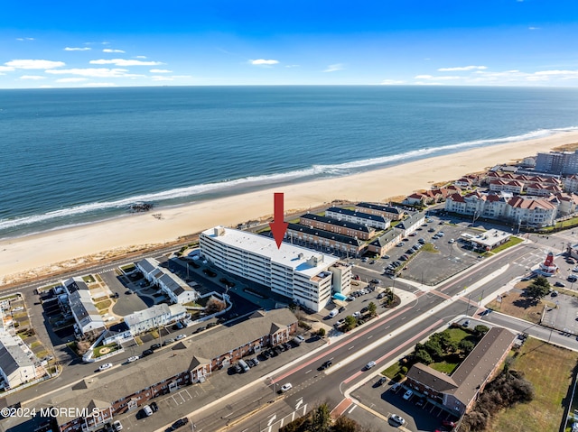 birds eye view of property with a view of the beach and a water view