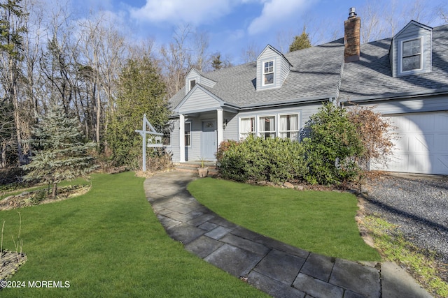 cape cod-style house featuring a garage and a front lawn