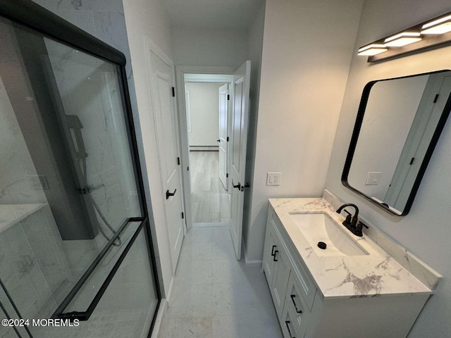 bathroom featuring a shower, vanity, and a baseboard heating unit