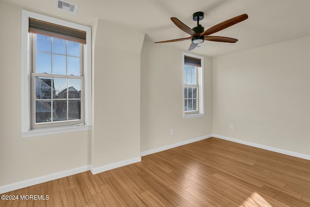 empty room with light hardwood / wood-style flooring and ceiling fan