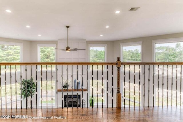 unfurnished living room featuring ceiling fan and a healthy amount of sunlight