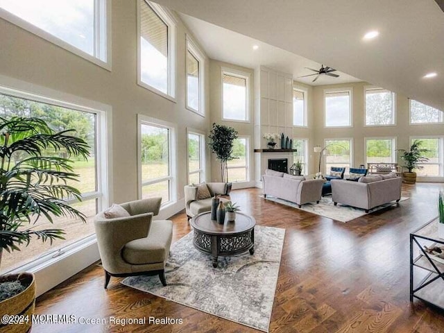 living room with a towering ceiling and a healthy amount of sunlight