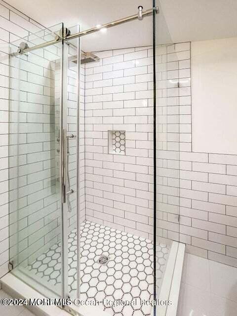 bathroom with tile patterned flooring and walk in shower