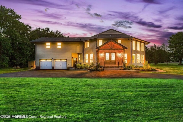 view of front of home featuring a garage and a lawn