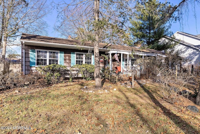 view of front of home featuring a front yard and covered porch