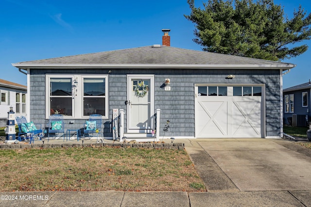 view of front of house with a front yard and a garage