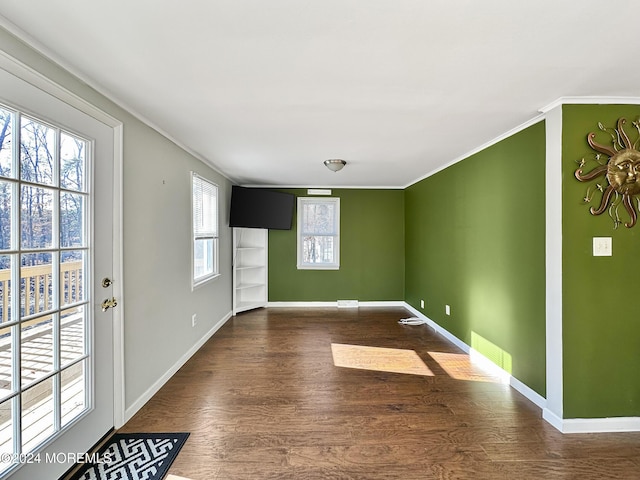 spare room with dark hardwood / wood-style floors and ornamental molding