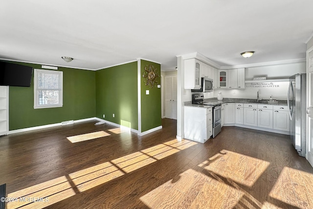 kitchen featuring white cabinets, appliances with stainless steel finishes, dark hardwood / wood-style floors, and sink