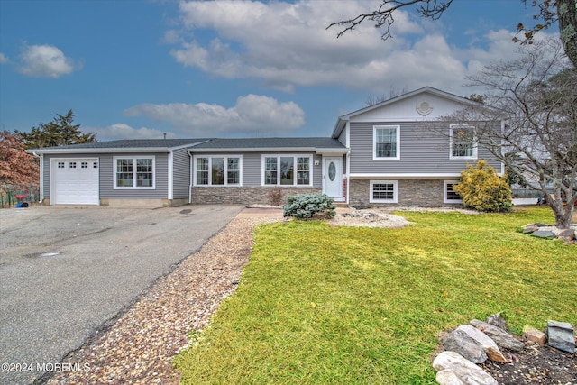 split level home with a front yard and a garage