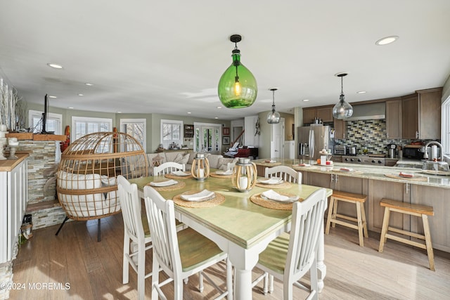 dining room featuring light wood-type flooring and sink