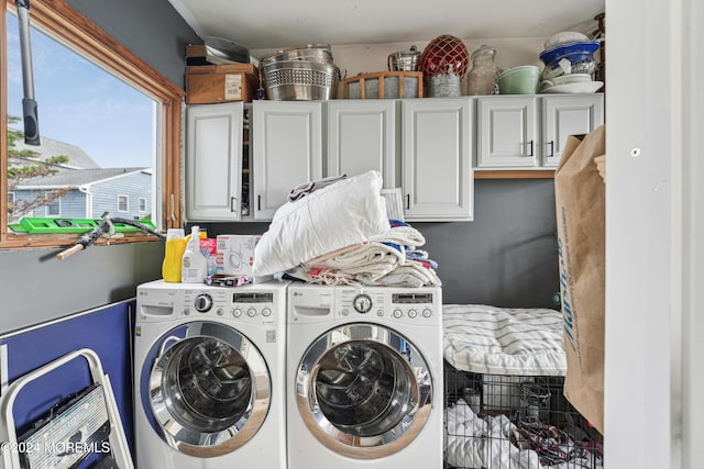 washroom with cabinets and independent washer and dryer