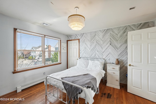 bedroom with dark hardwood / wood-style flooring and baseboard heating