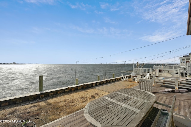 view of dock with a deck with water view