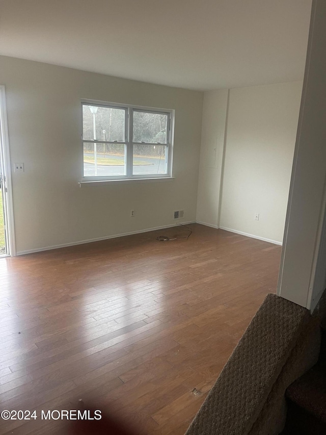 empty room with hardwood / wood-style floors