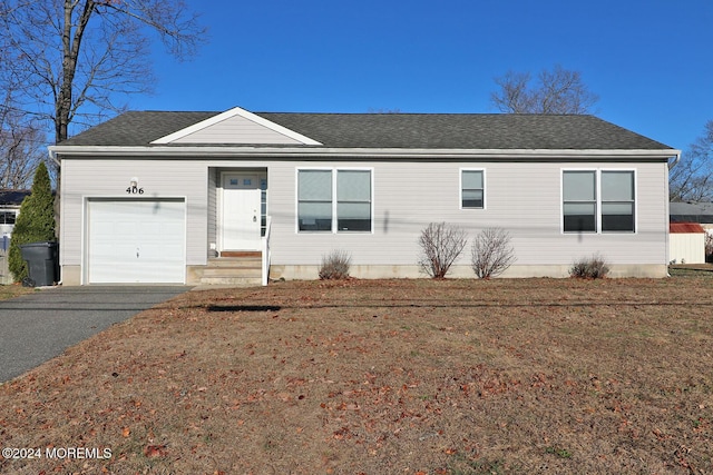 ranch-style home with a front yard and a garage