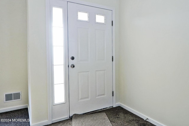 view of carpeted foyer