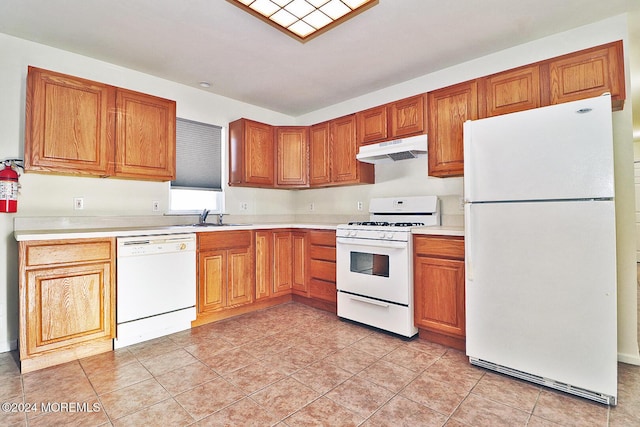 kitchen with light tile patterned flooring, white appliances, and sink