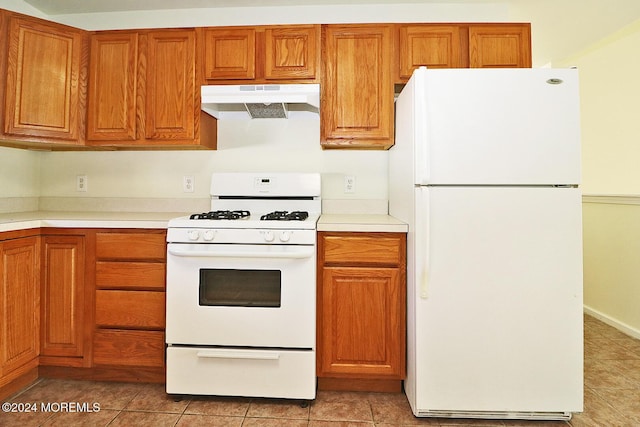 kitchen with white appliances and light tile patterned flooring