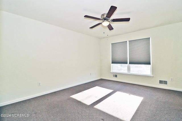 empty room featuring dark colored carpet and ceiling fan