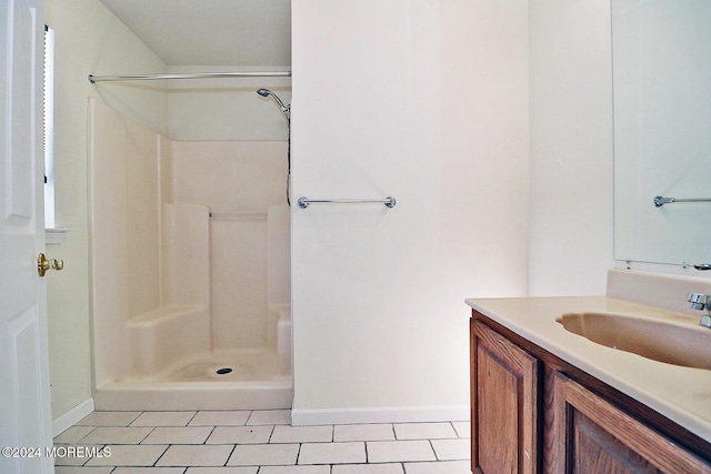 bathroom featuring tile patterned floors, vanity, and walk in shower